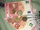 Euro bills and coins - one Euro is approximately $1.17