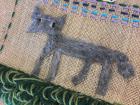 An elementary school student has cross-stitched a wolf as part of a school project because nature is a huge part of Finnish culture