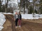 My sister and I standing outside of our childhood home, seeing it for the first time in 15 years.