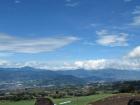 A common landscape in Costa Rica is rolling hills of agriculture and mountains in the distance