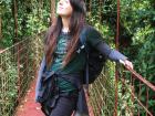 Taking a moment to admire the forest on a hanging bridge in the cloud forest