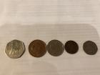From left to right: 50 pence piece, 2 pence, 10 pence, 1 pence, 20 pence (100 pence equals 1 pound)