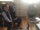 Children at a school in UB being weighed to check if they are at risk for having tuberculosis.
