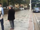 One man stands next to his freshly painted calligraphy 