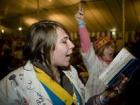 A woman reading off the lyrics to a traditional song during a Cantus