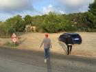 My friends with our rental car. We had pulled off to the side of the road to get a view of the morning sun rising over the water.