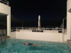 My friend going for a swim in our pool after dinner.