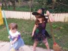 Irene (right) and her sister, both dressed up for Halloween as little brújulas (witches).