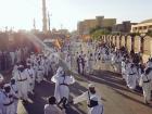 People marching streets during Mawlid while dancing and singing