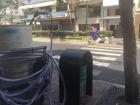 One of the street cleaners are busy at work just steps away from their cart