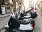 Rows of motorcycles all lined up throughout the city 