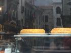 A restaurant window with tortilla española in it