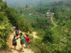 Two caring Hmong girls help Abby down the steep trail in Sa Pa.