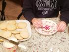 Abby decorates one of the gluten-free cookies with a red snowflake. 