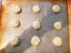 Abby places spoonfuls of gluten-free cookie dough on the baking sheet before placing them in the oven. 