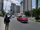 A man waves for a minibus to stop in the heart of La Paz