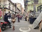 A woman in La Paz asks a police officer for advice to bypass all of the roadblocks and barricades 