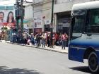 Salta residents patiently wait in line for the next bus
