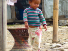 A Nepali child plays just outside of her home 