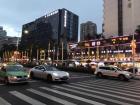 On the left is one of many green city taxis, which are a popular mode of transportation