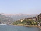 A breath-taking view of mountains, water, and a village in India