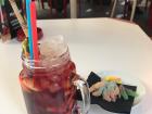 Sangria is a drink that is wine, orange juice, and chopped fruits; it was served here with gummies