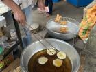 The dough circles frying in oil