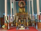 People kneel on the floor to pray to Buddha