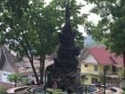 Bendis waiting in front of a statue of a great monster slain by the hero of myths, Bukittinggi