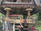 Posing with traditional Batak clothing— notice the sarong and headwear!