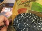 Here I am trying a burger with squid ink injected— yum!