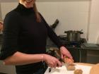 My friend is cutting a fresh baguette—  everyone helps at mealtime!