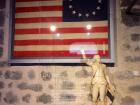 A model of Lafayette's statue and old American flag 