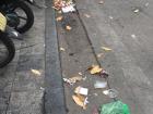 Many people throw garbage on side of the road or on the sidewalk 
