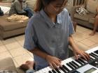 Playing piano at a friend's house in Kigali