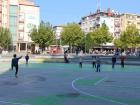 Playing soccer in the main square with some kids