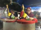 Students serving iced drinks at the night market