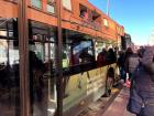 Many locals take the public bus too. Here, they are waiting in line to get on the bus.