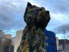 Outside of the Guggenheim Art Museum, there is a big sculpture made of real flowers. It is named "Puppy".