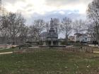 A small fountain and park in a residential neighborhood