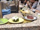 The plates at a revolving belt sushi restaurant go around for anyone to grab