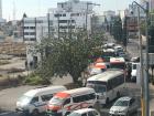 A street filled almost entirely with buses and combis