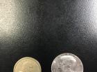 A gold dollar coin and 50 cent coin