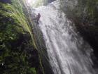 Rappelling down a waterfall in the Amazon while traveling with my mom