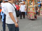 A costumed man marching with spectators