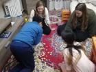 Playing shagai at a friend's house