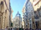 A street in old town that has a great view of the huge bank in Bucharest