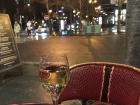 A picture of one of the typical French cafes where people seat outside facing the street