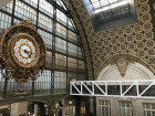 A cool metro station with a beautiful clock in the center of Paris