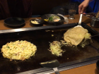 Here are two different types of okonomiyaki, traditional from Osaka and Hiroshima respectively